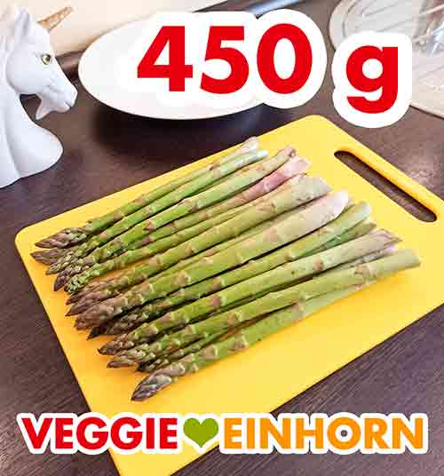 Ein Bund grüner Spargel sind ca. 450 g. 450 g grüner Spargel auf einem Schneidebrett.