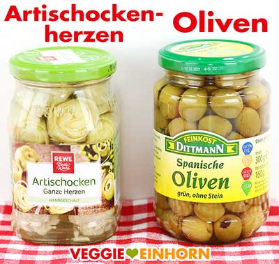 Artischockenherzen und grüne Oliven im Glas