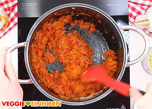 Reis, Ajvar und Knoblauch braten.
