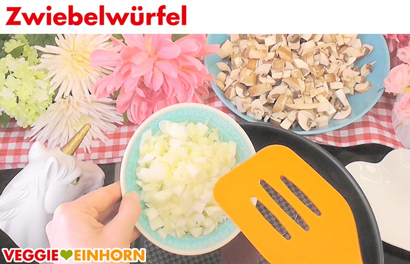Zwiebelwürfel werden in die Pfanne gegeben.