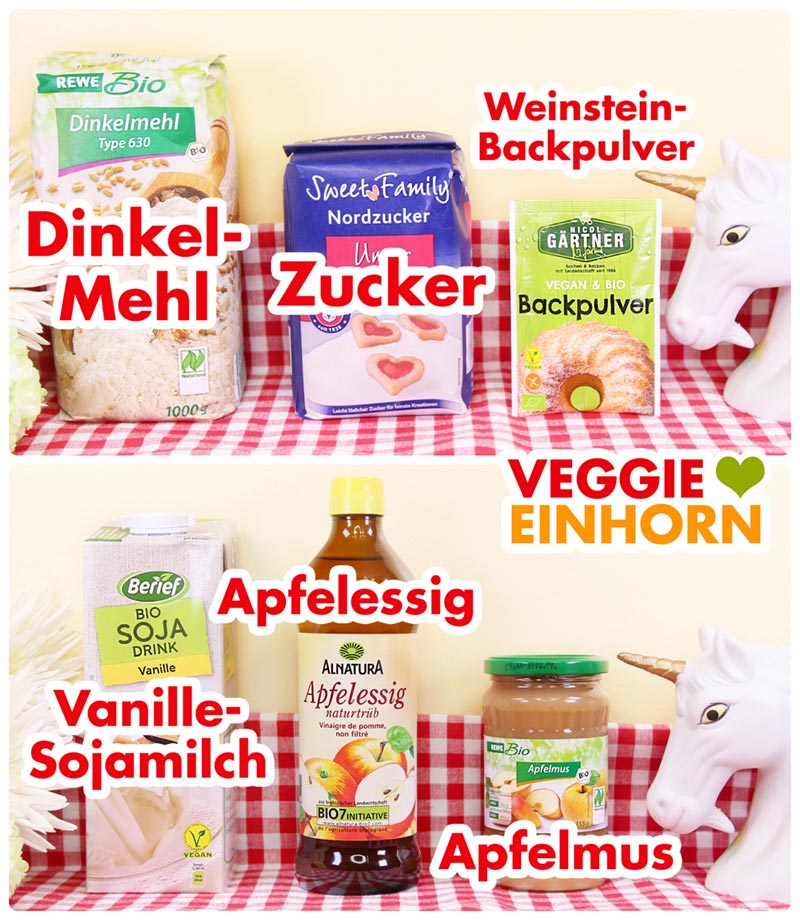 Zutaten für fluffige vegane Pancakes auf einem rot-weiß karierten Tuch: Dinkelmehl, Zucker, Weinstein-Backpulver, Vanille-Sojamilch, Apfelessig und Apfelmus.