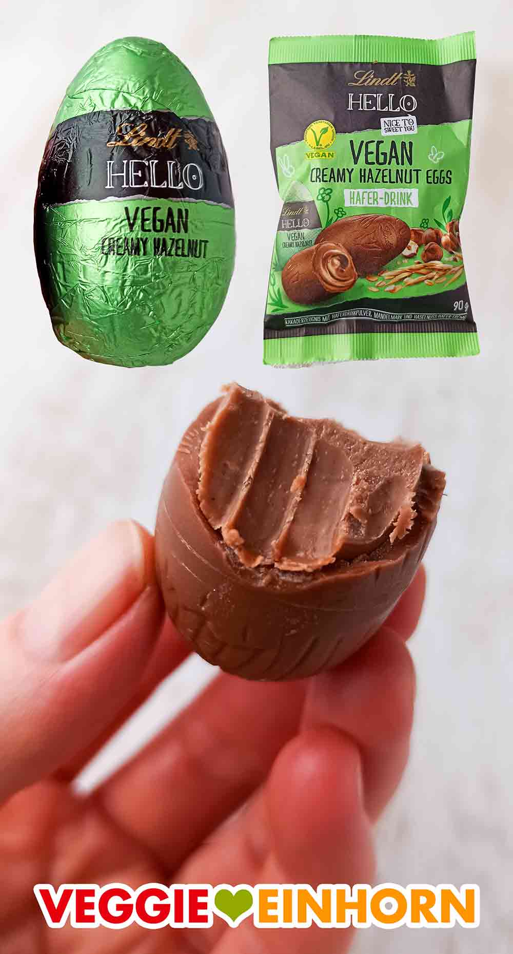 Die Eier schmecken wie gefüllte Nougat Ostereier. Ein angebissenes veganes Schokoei von Lindt Hello gefüllt mit Haselnusscreme