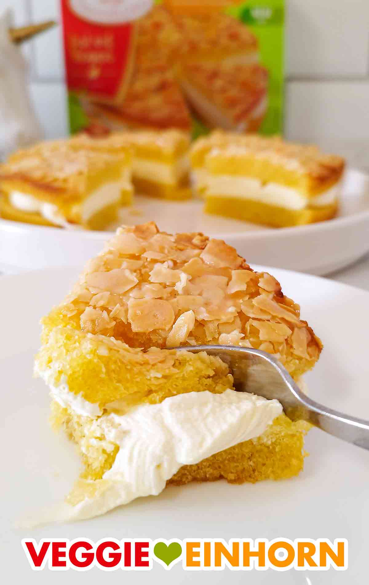 Hier sieht man die leckere vegane Sahnecreme Füllung. Veganer Bienenstich von Coppenrath und Wiese mit einer Kuchengabel