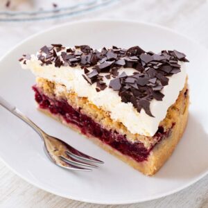 Ein Stück veganer Feuerwehrkuchen auf einem Kuchenteller. Daneben liegt eine Kuchengabel.