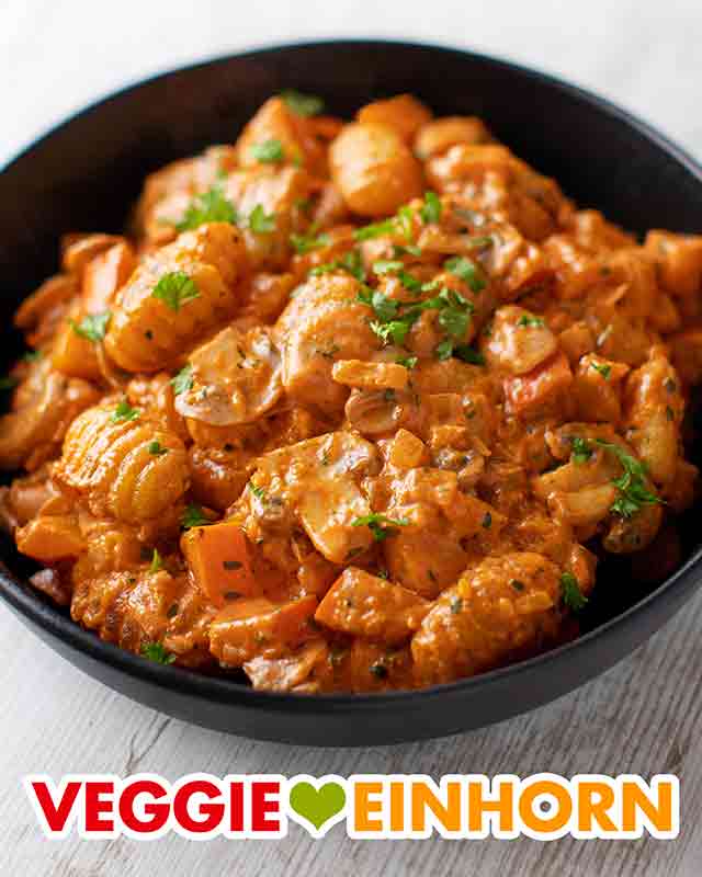 Teller mit veganer Gnocchipfanne mit Kürbis und Pilzen