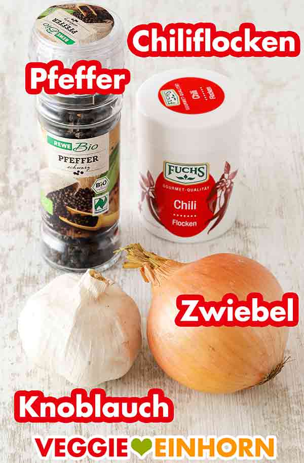Rewe Bio Pfeffermühle, Fuchs Chiliflocken, Knoblauch, Zwiebel Pfeffer, Chiliflocken, eine Knoblauchknolle und eine Zwiebel