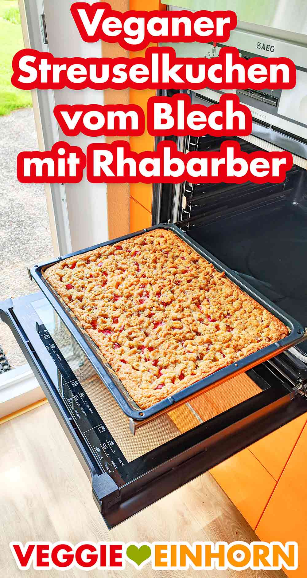 Ofenbackblech mit veganem Rhabarber Streuselkuchen Geöffneter Backofen mit veganem Rhabarberkuchen mit Streuseln auf dem Backblech