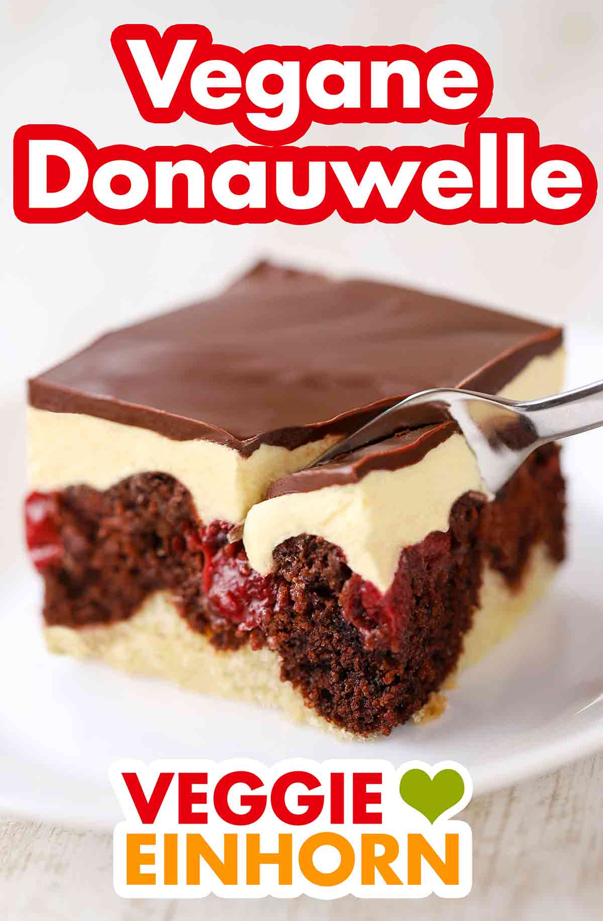 Die vegane Donauwelle ist ein beliebter veganer Kuchen. Ein Stück vegane Donauwelle mit einer Kuchengabel