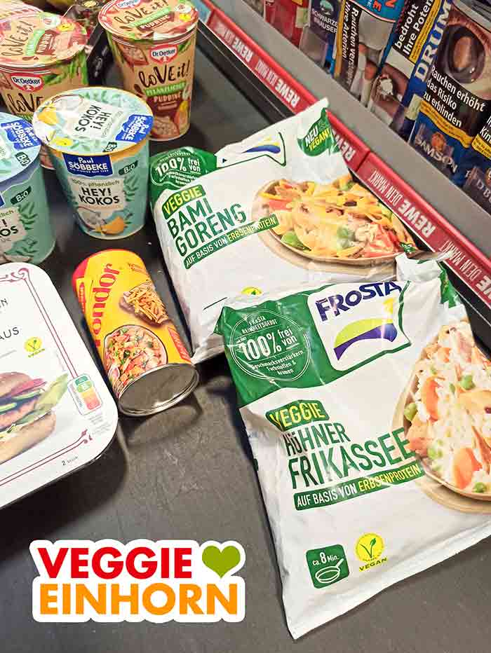 Vegane Lebensmittel an der Kasse bei Rewe Frosta Veggie Bami Goreng und Frosta Veggie Hühnerfrikassee auf dem Kassenband im Supermarkt