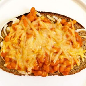 Überbackenes Brot mit Baked Beans aus der Dose und veganem Käse